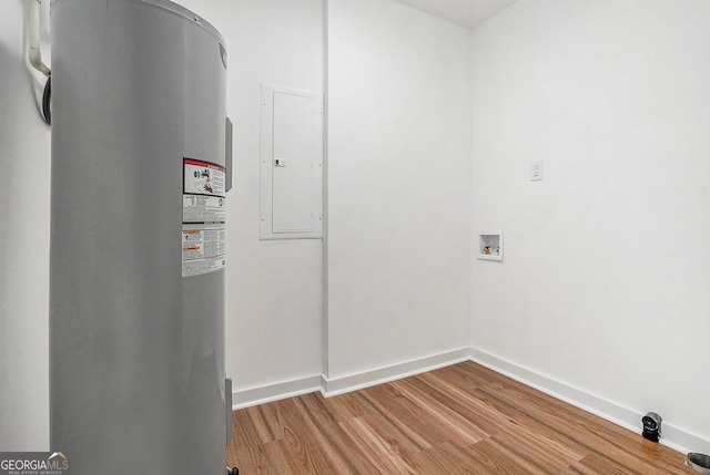 1852 Burwell Rd, Carrollton, GA 30117 - laundry area with water heater, electric panel, wood finished floors, baseboards, and washer hookup