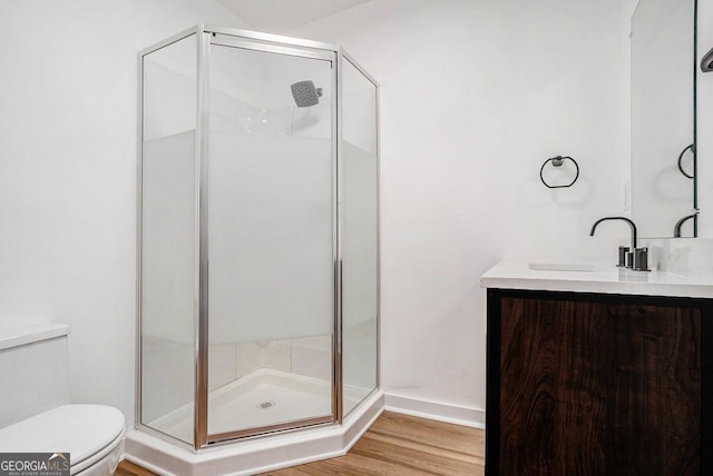 1852 Burwell Rd, Carrollton, GA 30117 - bathroom featuring toilet, a shower stall, vanity, and wood finished floors