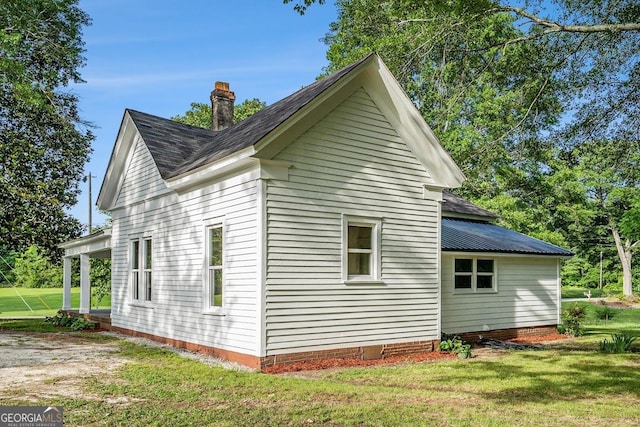 1852 Burwell Rd, Carrollton, GA 30117 - view of property exterior featuring a yard, a shingled roof, and a chimney