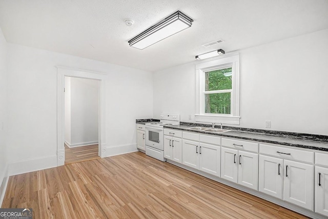 1852 Burwell Rd, Carrollton, GA 30117 - kitchen with white electric stove, light wood-style flooring, a sink, white cabinetry, and a textured ceiling