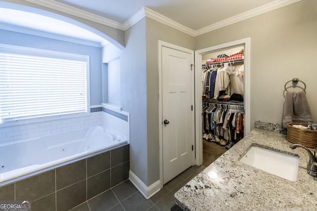 101 High Bluff Trl, Carrollton, GA 30116 - bathroom featuring tile patterned flooring, a tub with jets, ornamental molding, a spacious closet, and vanity