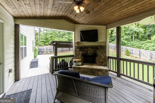 101 High Bluff Trl, Carrollton, GA 30116 - deck featuring an outdoor stone fireplace, a ceiling fan, and a fenced backyard