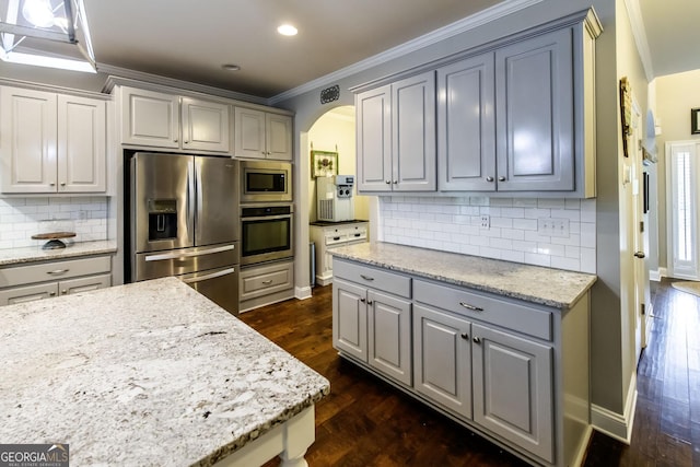 101 High Bluff Trl, Carrollton, GA 30116 - kitchen with stainless steel appliances, arched walkways, dark wood-style floors, gray cabinetry, and crown molding