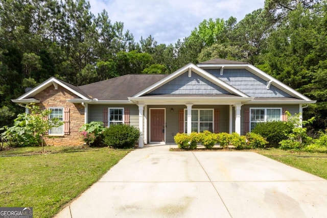 6770 Gordon Manor Ct SW, Mableton, GA 30126 - view of front of property featuring stone siding, a front yard, a porch, and view of scattered trees