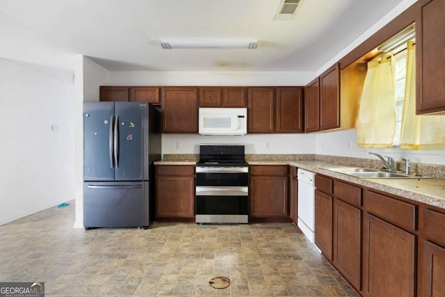 6770 Gordon Manor Ct SW, Mableton, GA 30126 - kitchen featuring white appliances, light countertops, and stone finish flooring