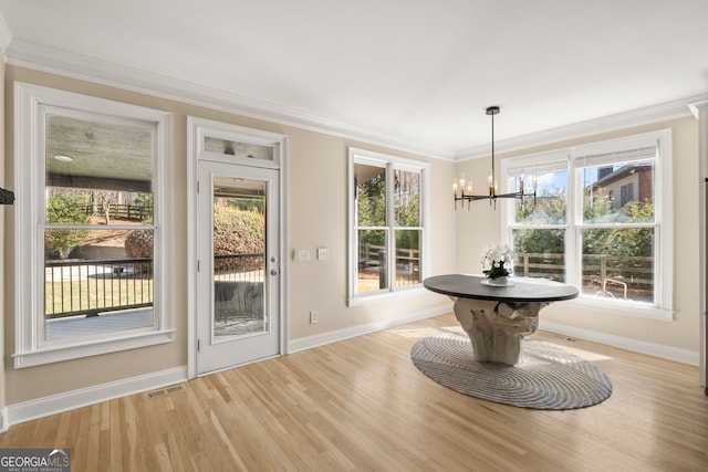 410 S Burgess Trl, Milton, GA 30004 - doorway with baseboards, ornamental molding, light wood finished floors, a chandelier, and plenty of natural light