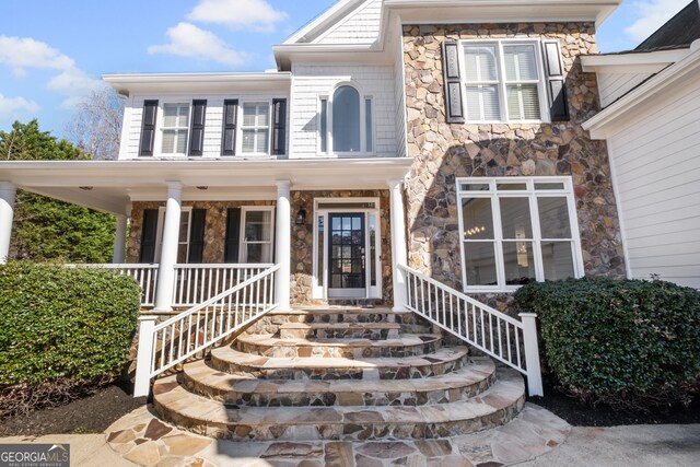 410 S Burgess Trl, Milton, GA 30004 - view of exterior entry with stone siding and covered porch