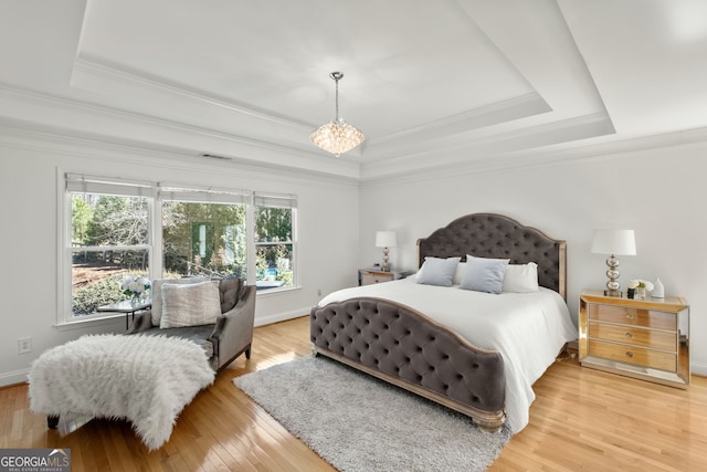 410 S Burgess Trl, Milton, GA 30004 - bedroom featuring a tray ceiling, ornamental molding, light wood-style floors, baseboards, and a chandelier