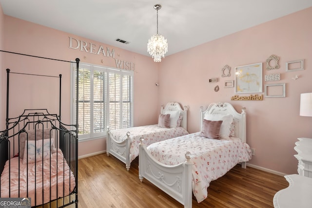 410 S Burgess Trl, Milton, GA 30004 - bedroom with light wood-style flooring, baseboards, and a chandelier