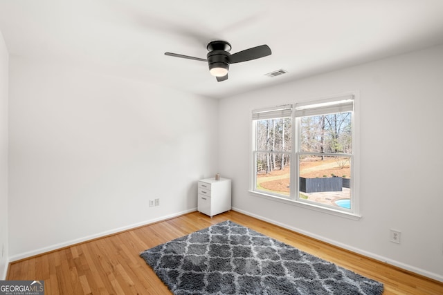 410 S Burgess Trl, Milton, GA 30004 - spare room with baseboards, ceiling fan, and wood finished floors