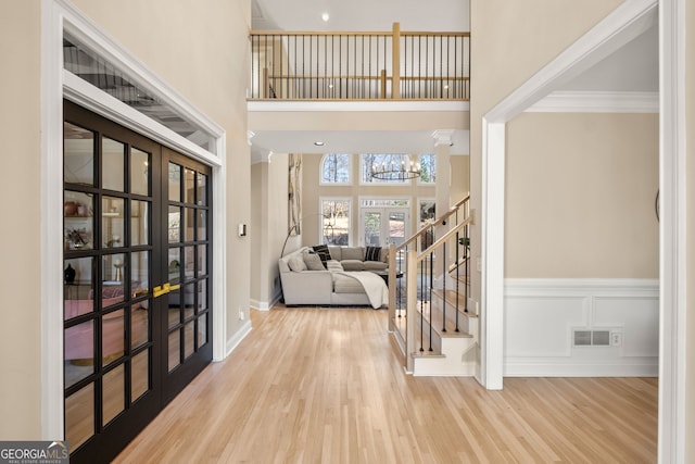 410 S Burgess Trl, Milton, GA 30004 - foyer entrance with wood finished floors, stairway, a chandelier, french doors, and a towering ceiling