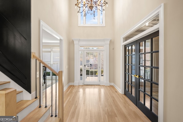 410 S Burgess Trl, Milton, GA 30004 - entrance foyer with a chandelier, wood finished floors, stairway, baseboards, and a high ceiling