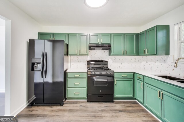131 Turning Pt, Stockbridge, GA 30281 - kitchen featuring refrigerator with ice dispenser, black gas range, under cabinet range hood, light countertops, and green cabinets
