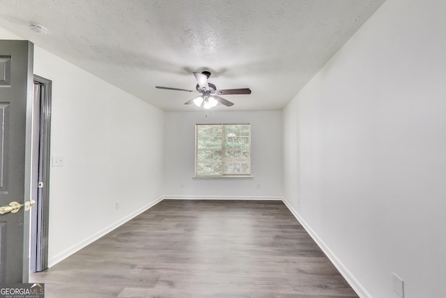 131 Turning Pt, Stockbridge, GA 30281 - unfurnished room featuring ceiling fan, dark wood finished floors, a textured ceiling, a smoke detector, and baseboards