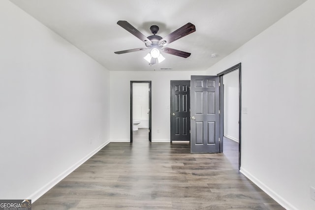 131 Turning Pt, Stockbridge, GA 30281 - unfurnished bedroom with wood finished floors, baseboards, and ceiling fan