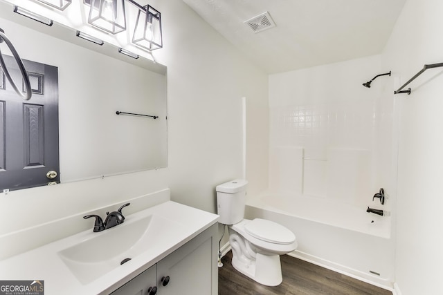 131 Turning Pt, Stockbridge, GA 30281 - bathroom featuring wood finished floors, toilet, vanity, and bathing tub / shower combination