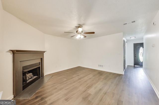 131 Turning Pt, Stockbridge, GA 30281 - unfurnished living room featuring a ceiling fan, wood finished floors, a fireplace, and baseboards