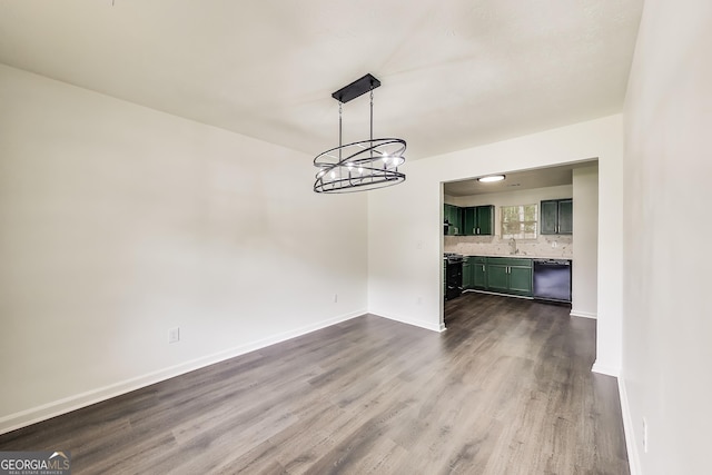 131 Turning Pt, Stockbridge, GA 30281 - unfurnished dining area featuring a sink, dark wood finished floors, a chandelier, and baseboards