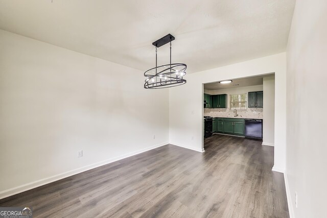 131 Turning Pt, Stockbridge, GA 30281 - unfurnished dining area with dark wood finished floors and a chandelier