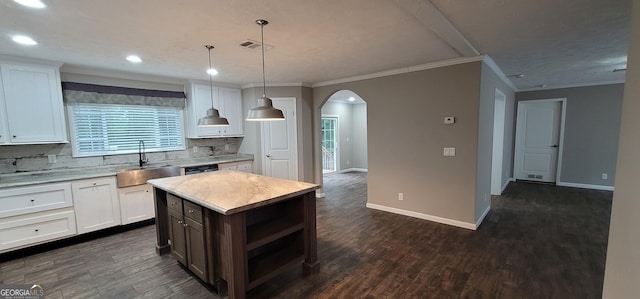 4373 Whiporwill Rd, Gillsville, GA 30543 - kitchen with a sink, arched walkways, white cabinetry, decorative backsplash, and dark wood-type flooring