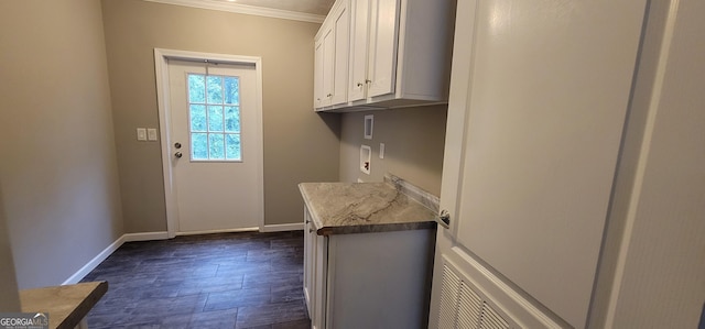 4373 Whiporwill Rd, Gillsville, GA 30543 - washroom with crown molding, washer hookup, cabinet space, baseboards, and dark wood-style floors