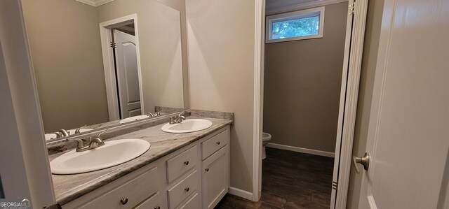 4373 Whiporwill Rd, Gillsville, GA 30543 - bathroom with toilet, double vanity, baseboards, wood finished floors, and ornamental molding