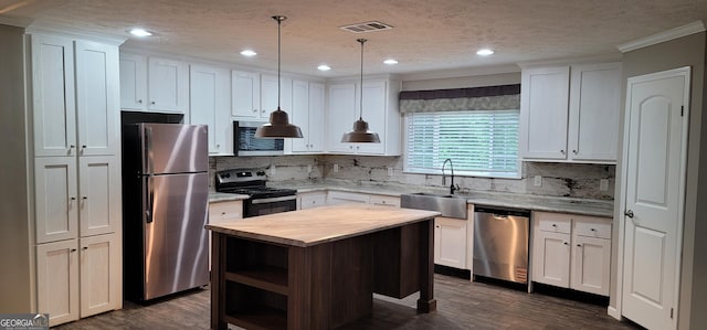 4373 Whiporwill Rd, Gillsville, GA 30543 - kitchen featuring stainless steel appliances, a sink, wood counters, ornamental molding, and tasteful backsplash