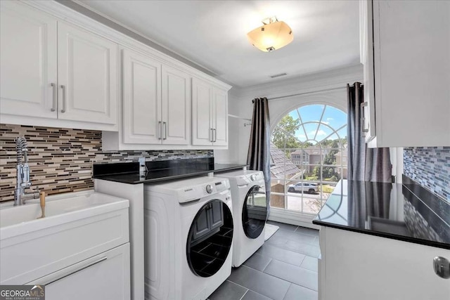 3400 Dencrest Ct SE, Smyrna, GA 30080 - laundry room with washer and clothes dryer, dark tile patterned floors, and cabinet space