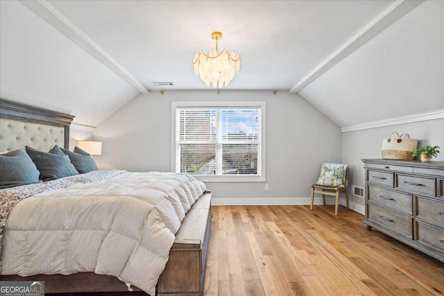 2291 Mission Oak Ter, Grayson, GA 30017 - bedroom featuring vaulted ceiling, light wood-style floors, a chandelier, and baseboards