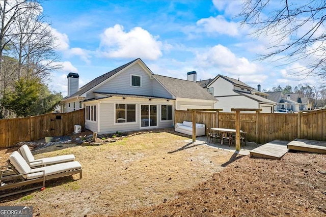 2291 Mission Oak Ter, Grayson, GA 30017 - back of property with a chimney and a fenced backyard