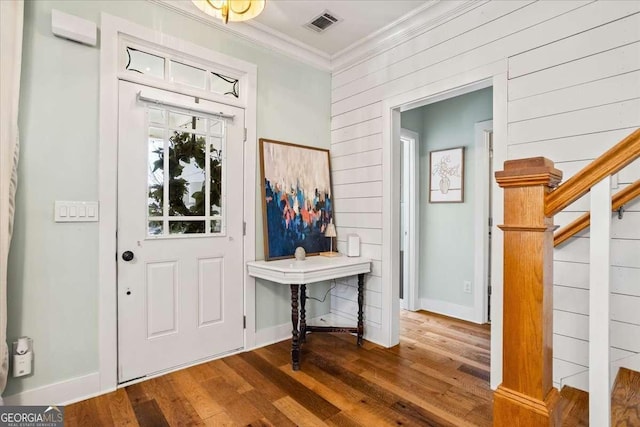 2291 Mission Oak Ter, Grayson, GA 30017 - foyer entrance featuring ornamental molding, wood finished floors, stairway, wooden walls, and baseboards