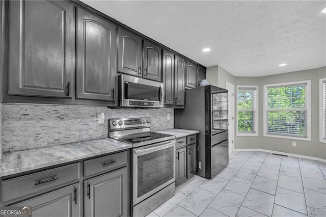 107 Timothy Ln, Bethlehem, GA 30620 - kitchen with appliances with stainless steel finishes, light marble finish flooring, recessed lighting, decorative backsplash, and light stone countertops
