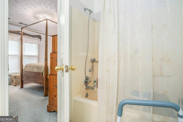 844 Potomac Pl, Winder, GA 30680 - ensuite bathroom with shower / bath combo with shower curtain and a textured ceiling