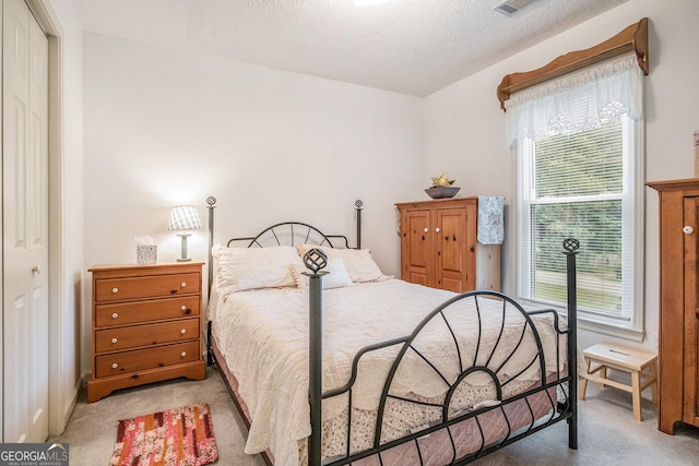 844 Potomac Pl, Winder, GA 30680 - bedroom with light colored carpet, multiple windows, and a textured ceiling