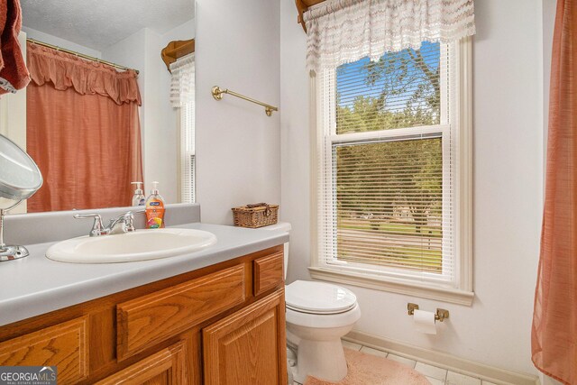 844 Potomac Pl, Winder, GA 30680 - full bath with toilet, tile patterned flooring, vanity, and plenty of natural light
