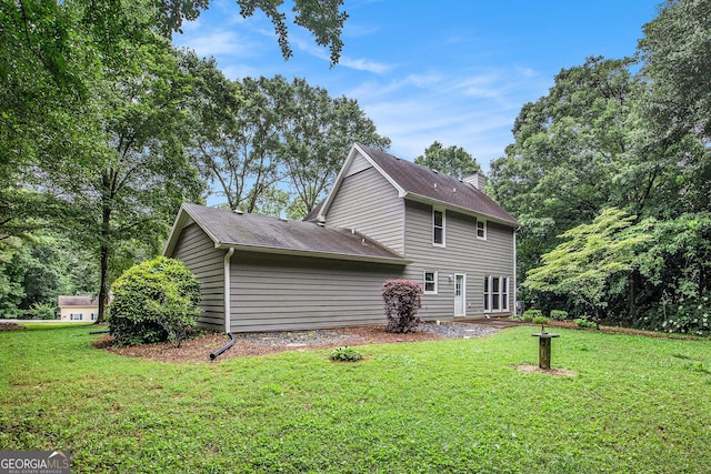 844 Potomac Pl, Winder, GA 30680 - view of side of property featuring a lawn, a chimney, and a shingled roof