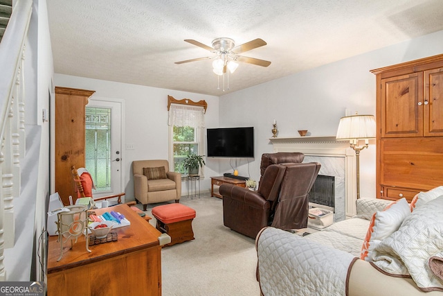 844 Potomac Pl, Winder, GA 30680 - living room featuring light colored carpet, ceiling fan, a premium fireplace, and a textured ceiling