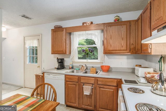 844 Potomac Pl, Winder, GA 30680 - kitchen featuring white appliances, a sink, light countertops, brown cabinetry, and a textured ceiling