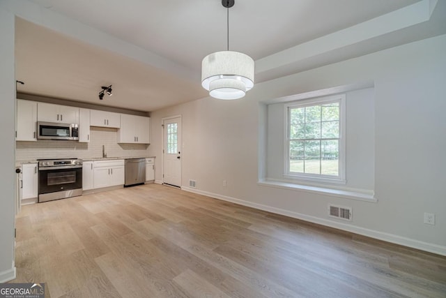 3404 Broxton Mill Way, Snellville, GA 30039 - kitchen featuring stainless steel appliances, light wood-style flooring, white cabinets, and light countertops