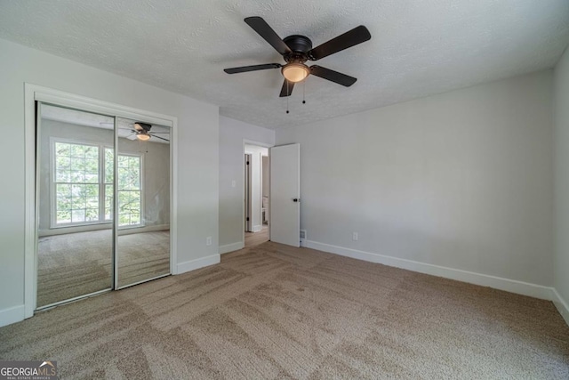 3404 Broxton Mill Way, Snellville, GA 30039 - unfurnished bedroom with carpet flooring, a textured ceiling, a closet, and a ceiling fan