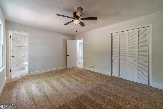 3404 Broxton Mill Way, Snellville, GA 30039 - unfurnished bedroom with a closet, a textured ceiling, carpet, connected bathroom, and ceiling fan