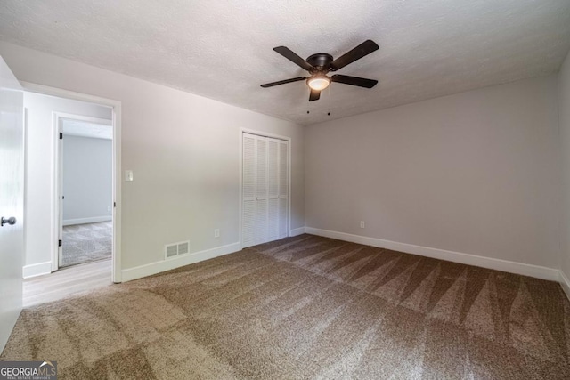 3404 Broxton Mill Way, Snellville, GA 30039 - unfurnished bedroom featuring carpet floors, a closet, a ceiling fan, and a textured ceiling