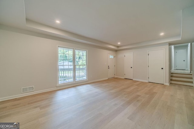 3404 Broxton Mill Way, Snellville, GA 30039 - unfurnished living room featuring a raised ceiling, light wood finished floors, and recessed lighting