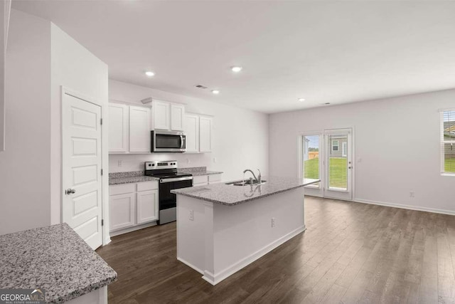 620 Lobelia Way, Locust Grove, GA 30248 - kitchen with stainless steel appliances, dark wood finished floors, white cabinets, an island with sink, and recessed lighting