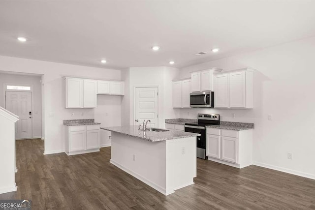 620 Lobelia Way, Locust Grove, GA 30248 - kitchen featuring stainless steel appliances, white cabinetry, dark wood-style floors, a center island with sink, and recessed lighting