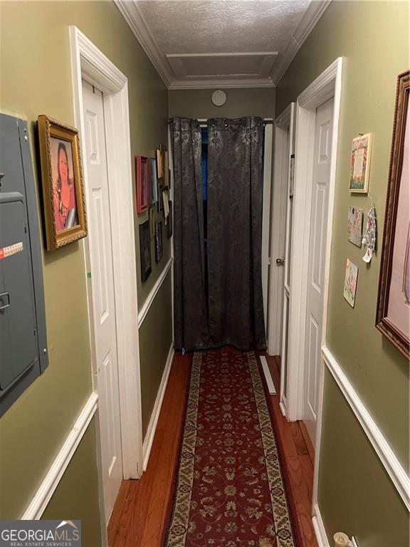 60 King Blvd, Mcdonough, GA 30253 - corridor featuring electric panel, wood finished floors, ornamental molding, and a textured ceiling