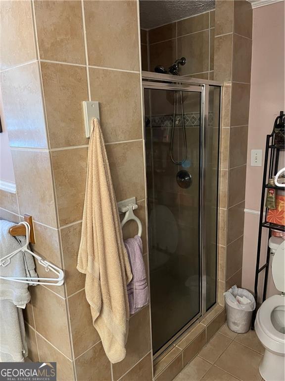 60 King Blvd, Mcdonough, GA 30253 - full bathroom featuring a stall shower and tile patterned flooring