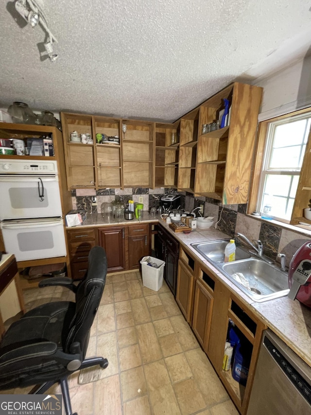 938 Mandeville Rd, Carrollton, GA 30117 - kitchen with open shelves, a sink, backsplash, double oven, and a textured ceiling