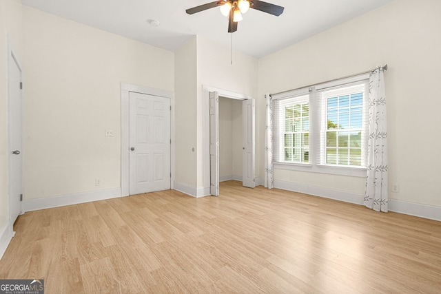 6802 Ida St, Lithonia, GA 30058 - unfurnished bedroom featuring light wood-style floors and ceiling fan