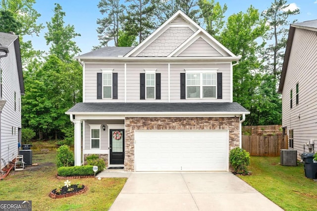 2939 Woodward Down Trl, Buford, GA 30519 - craftsman-style home featuring concrete driveway, an attached garage, stone siding, and central AC unit